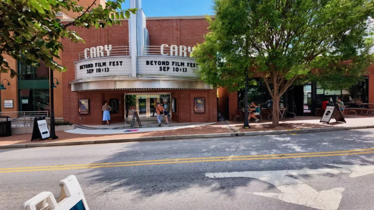 The Cary Theater's art deco marquee over the entrance, with people on the sidewalk and a crosswalk in front